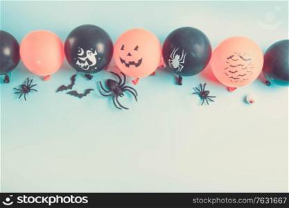 Halloween scene with balloons and spiders border on blue background, retro toned. Halloween scene with balloons