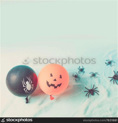 Halloween scene with to scary balloons on blue background, retro toned. Halloween scene with balloons