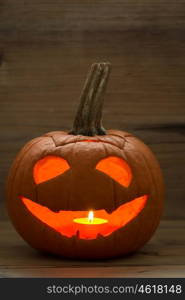 Halloween. Smiling lantern pumpkin on a wooden background