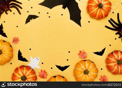 Halloween symbol concept, Scary smile pumpkin with spider and bat with ghost on yellow background.