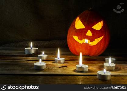 Halloween symbol smiling pumpkin lantern and burning candles. Halloween symbol smiling pumpkin lantern and burning candles. Halloween jack-o-lantern and burning candles background.