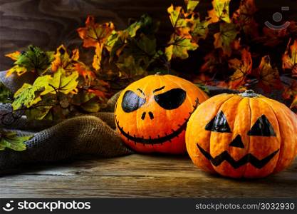 Halloween symbol smiling pumpkin on dark rustic background. Halloween symbol smiling pumpkin on dark rustic background. Halloween jack-o-lantern and burning candles background.