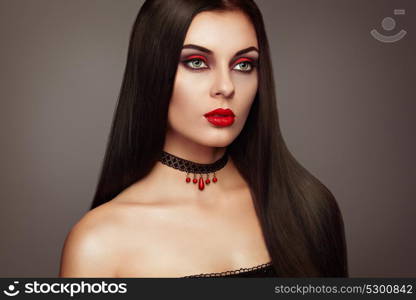 Halloween Vampire Woman portrait. Beautiful Glamour Fashion Sexy Vampire Lady with long dark Hair, beauty Make Up and Costume