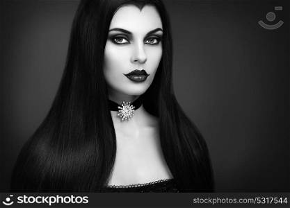 Halloween Vampire Woman portrait. Beautiful Glamour Fashion Sexy Vampire Lady with Long Dark Hair, Beauty Make Up and Costume