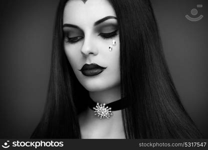 Halloween Vampire Woman portrait. Beautiful Glamour Fashion Sexy Vampire Lady with Long Dark Hair, Beauty Make Up and Costume