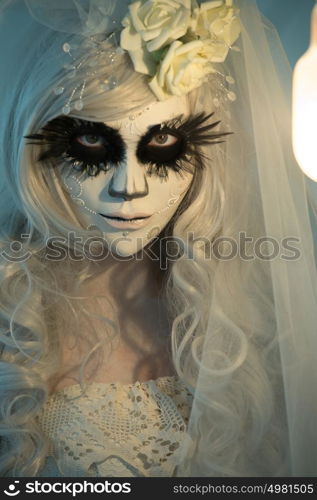 Halloween witch. Beautiful woman wearing santa muerte mask portrait