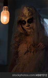 Halloween witch. Beautiful woman wearing santa muerte mask portrait