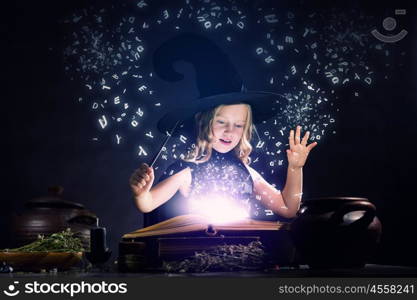 Halloween witch. Little Halloween witch reading conjure above pot