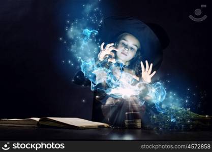 Halloween witch. Little Halloween witch reading conjure above pot