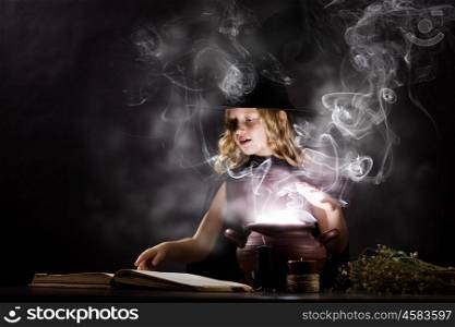 Halloween witch. Little Halloween witch reading conjure above pot