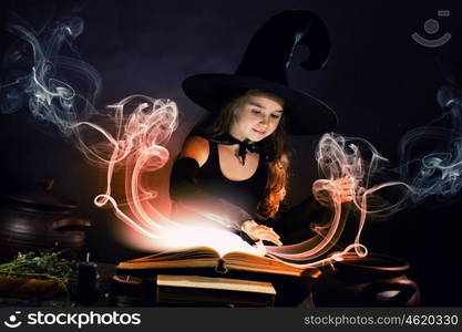 Halloween witch. Little Halloween witch reading conjure above pot