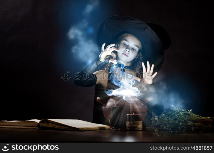 Halloween witch. Little Halloween witch reading conjure above pot