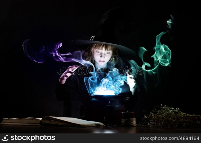 Halloween witch. Little Halloween witch reading conjure above pot