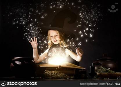 Halloween witch. Little Halloween witch reading conjure from magic book