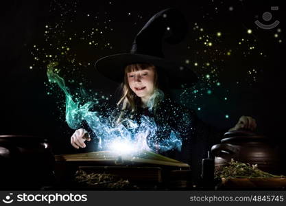 Halloween witch. Little Halloween witch reading conjure from magic book