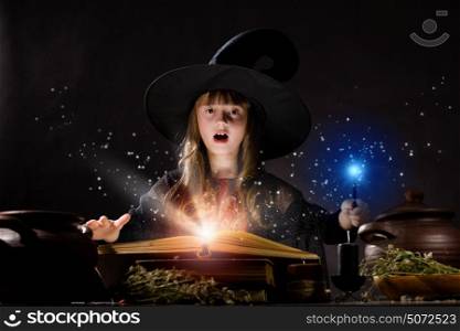 Halloween witch. Little Halloween witch reading conjure from magic book
