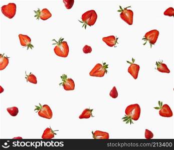 Halves of a fresh strawberry with green leaves on a gray background. Creative pattern of berries, flat lay. Pattern of fresh halves of ripe strawberries on a gray background