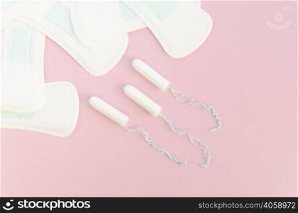 halves pads tampons pink background