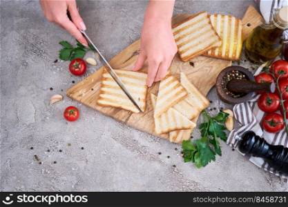 Halving Toasted Bread Slices on wooden cutting board for breakfast.. Halving Toasted Bread Slices on wooden cutting board for breakfast