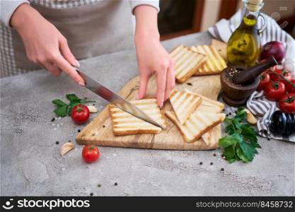 Halving Toasted Bread Slices on wooden cutting board for breakfast.. Halving Toasted Bread Slices on wooden cutting board for breakfast