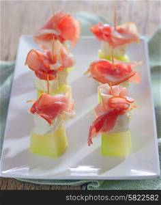 Ham, cheese and melon on plate