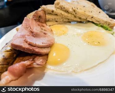 Ham, egg, bacon, German sausage and toast brunch