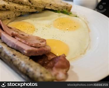 Ham, egg, bacon, German sausage and toast brunch