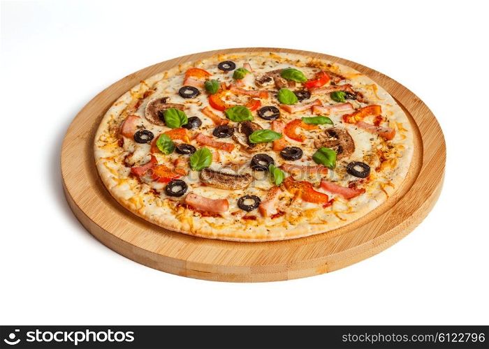 Ham pizza with capsicum, mushrooms, olives and basil leaves isolated on white