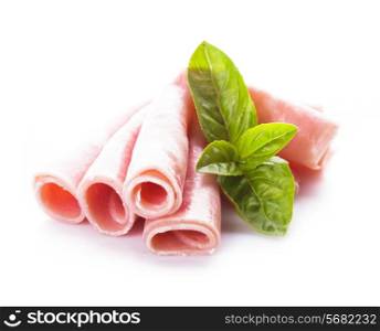 Ham slices isolated on white with green basil leaves
