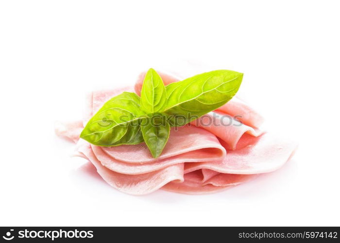 Ham slices isolated on white with green basil leaves. Ham slices isolated