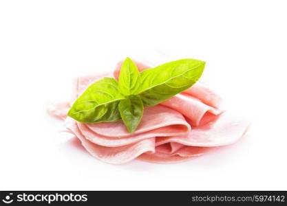 Ham slices isolated on white with green basil leaves. Ham slices isolated