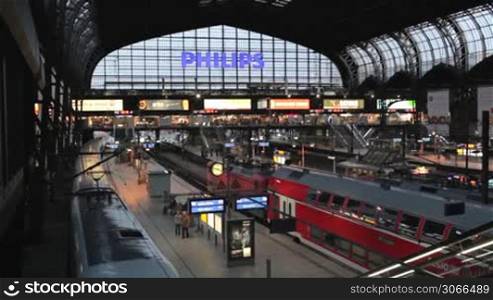 hamburg - may 30: central railway station with large philips logo, trains and moving passengers on may, 30, 2012 in hamburg, germany.