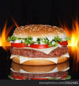 Hamburger on black background with refletion and real fire