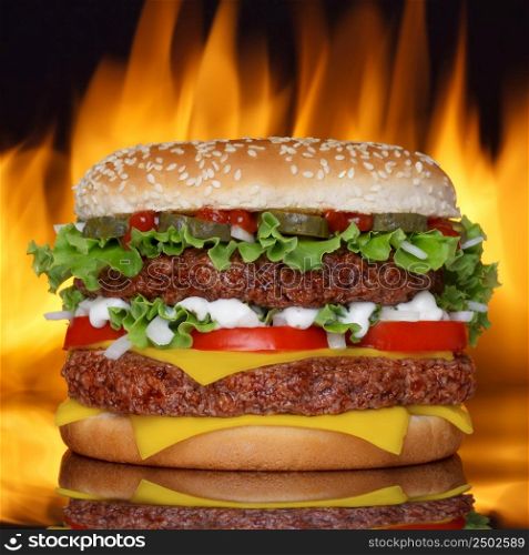 Hamburger on black background with refletion and real fire on back