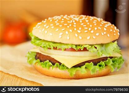 Hamburger on brown paper on a wooden tabletop