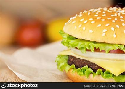 Hamburger on brown paper on a wooden tabletop