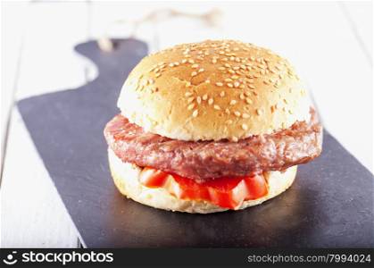 Hamburger sandwich over black stone, horizontal image