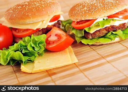 hamburger with cutlet and vegetables on bamboo napkin