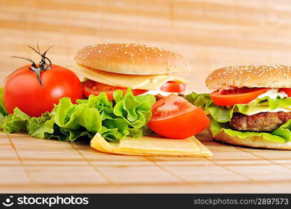 hamburger with cutlet and vegetables on bamboo napkin