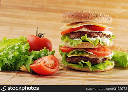 hamburger with cutlet and vegetables on bamboo napkin