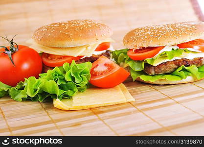 hamburger with cutlet and vegetables on bamboo napkin