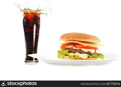 hamburger with cutlet and vegetables on dish with fresh sparking drink