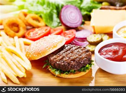 hamburger with fresh vegetables on wooden table