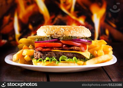 hamburger with fries on wooden table