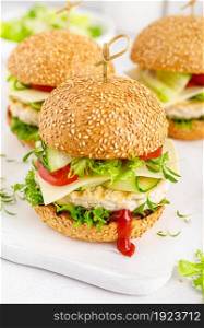 Hamburger with grilled chicken burger, fresh cucumber, tomato, cheese and lettuce.