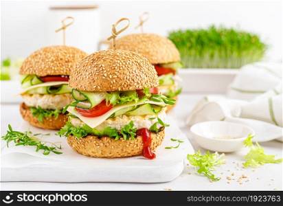 Hamburger with grilled chicken burger, fresh cucumber, tomato, cheese and lettuce.