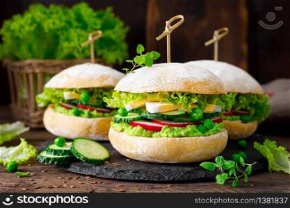 Hamburger with homemade ciabatta bun bread, boiled egg, radish, cucumber, lettuce salad and puree of fresh green peas