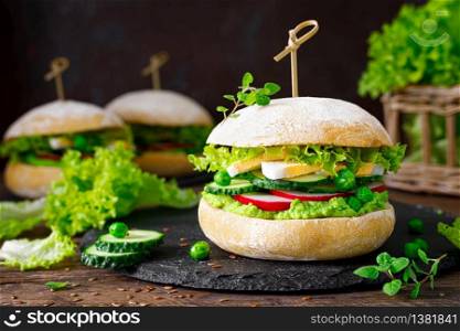 Hamburger with homemade ciabatta bun bread, boiled egg, radish, cucumber, lettuce salad and puree of fresh green peas