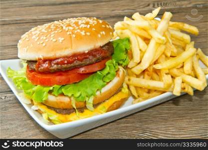 hamburger with potatoes on wooden background