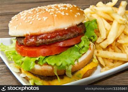hamburger with potatoes on wooden background